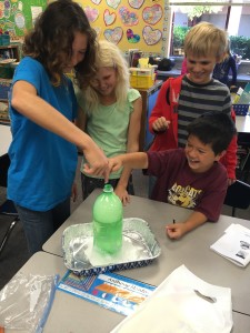 Dorothea Lange students explore a volcano made from baking soda and vinegar while learning about igneous rocks.